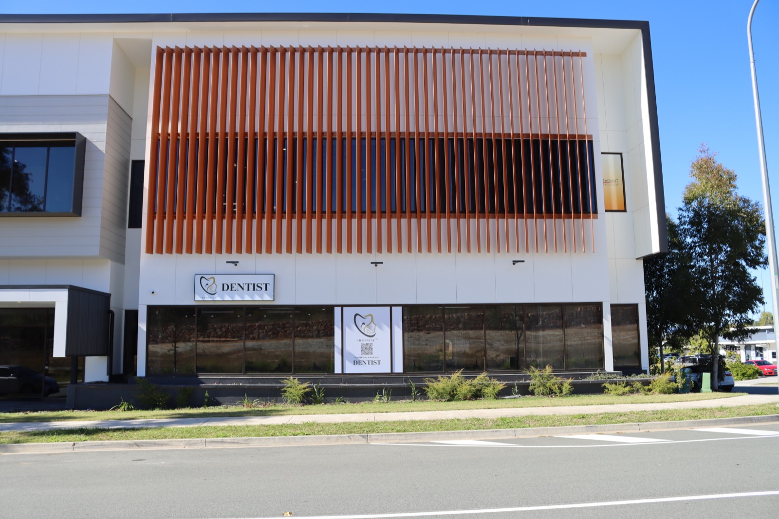 FB Dental building with orange slat facade and DENTIST sign on Adler Circuit Yarrabilba
